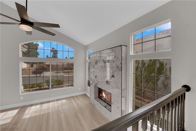 1611 Buffalo Trail Dr, Henderson, NV 89014 - unfurnished living room with plenty of natural light, a tile fireplace, lofted ceiling, baseboards, and a ceiling fan