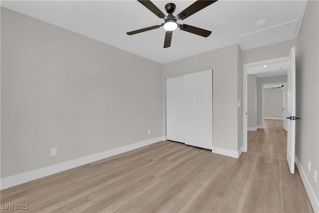 1611 Buffalo Trail Dr, Henderson, NV 89014 - unfurnished bedroom with attic access, light wood-type flooring, a closet, baseboards, and ceiling fan