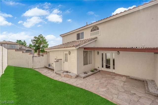 1611 Buffalo Trail Dr, Henderson, NV 89014 - rear view of property featuring a tile roof, a patio area, stucco siding, and french doors