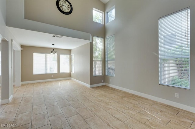 1917 Badger Canyon Ave, North Las Vegas, NV 89031 - spare room with a chandelier, baseboards, and light tile patterned floors