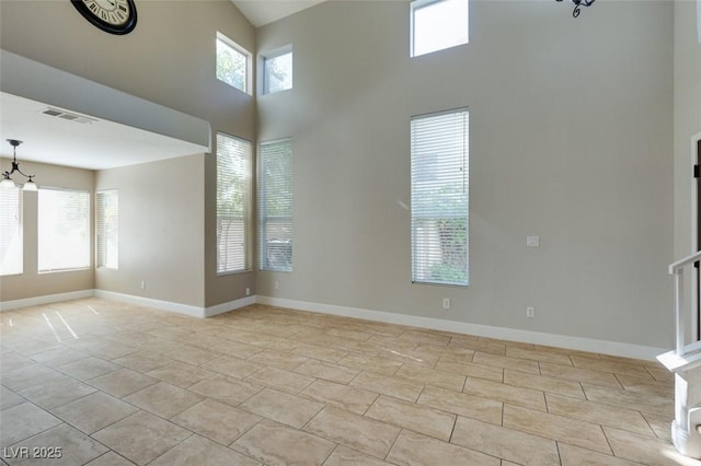 1917 Badger Canyon Ave, North Las Vegas, NV 89031 - spare room featuring a chandelier, baseboards, and a high ceiling