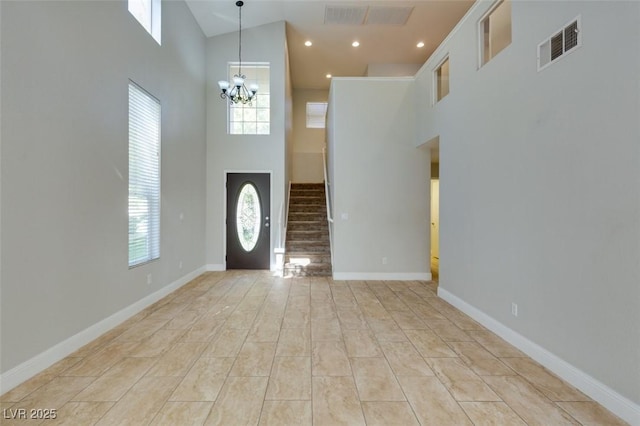 1917 Badger Canyon Ave, North Las Vegas, NV 89031 - entrance foyer with a towering ceiling, stairway, healthy amount of natural light, a chandelier, and baseboards