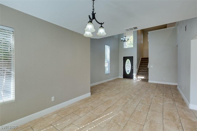 1917 Badger Canyon Ave, North Las Vegas, NV 89031 - foyer with a chandelier, stairs, baseboards, and light tile patterned floors