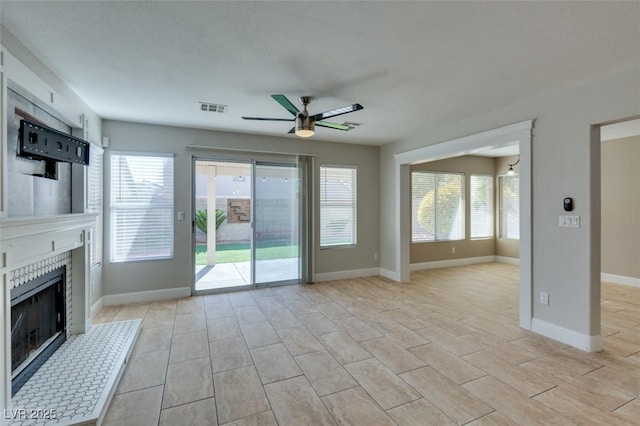 1917 Badger Canyon Ave, North Las Vegas, NV 89031 - unfurnished living room featuring a ceiling fan, a fireplace, and baseboards