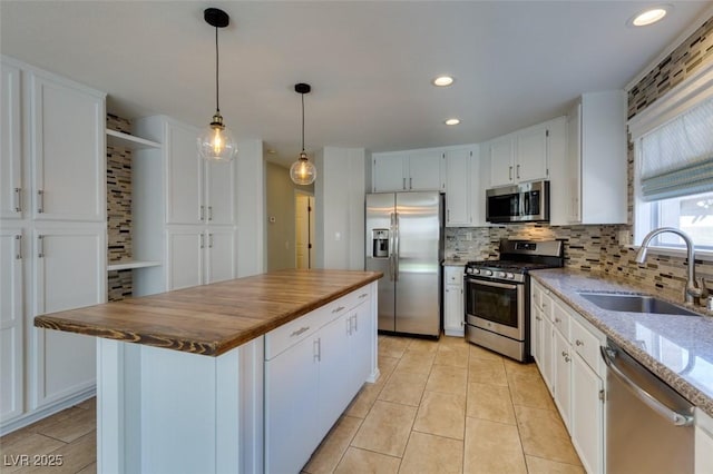 1917 Badger Canyon Ave, North Las Vegas, NV 89031 - kitchen with appliances with stainless steel finishes, a sink, tasteful backsplash, white cabinetry, and dark stone countertops