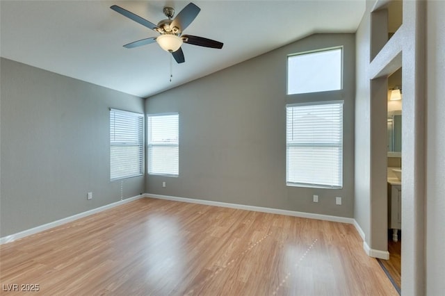 1917 Badger Canyon Ave, North Las Vegas, NV 89031 - spare room featuring lofted ceiling, light wood-style floors, ceiling fan, and baseboards