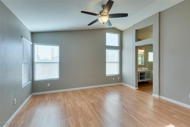 1917 Badger Canyon Ave, North Las Vegas, NV 89031 - spare room with light wood-style flooring, a ceiling fan, lofted ceiling, and baseboards