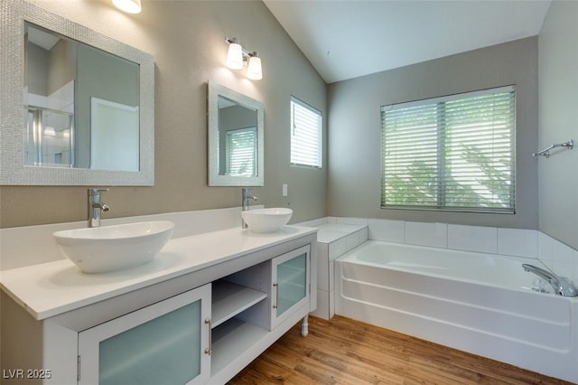 1917 Badger Canyon Ave, North Las Vegas, NV 89031 - full bath with vaulted ceiling, a bath, wood finished floors, double vanity, and a shower with door