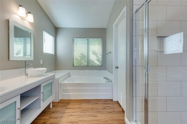 1917 Badger Canyon Ave, North Las Vegas, NV 89031 - bathroom featuring a bath, double vanity, wood finished floors, and a shower stall