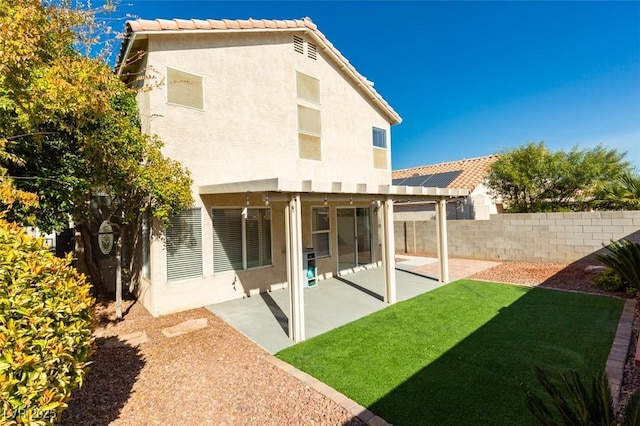 1917 Badger Canyon Ave, North Las Vegas, NV 89031 - rear view of house featuring stucco siding, a patio area, and a tiled roof