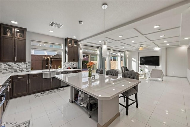6618 Tangled Vines Ave, Las Vegas, NV 89139 - kitchen with a sink, backsplash, dark brown cabinets, coffered ceiling, and recessed lighting