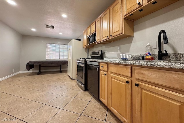 6929 Montcliff Ave, Las Vegas, NV 89147 - kitchen with light tile patterned floors, black microwave, stainless steel range with electric cooktop, dishwasher, and a textured ceiling