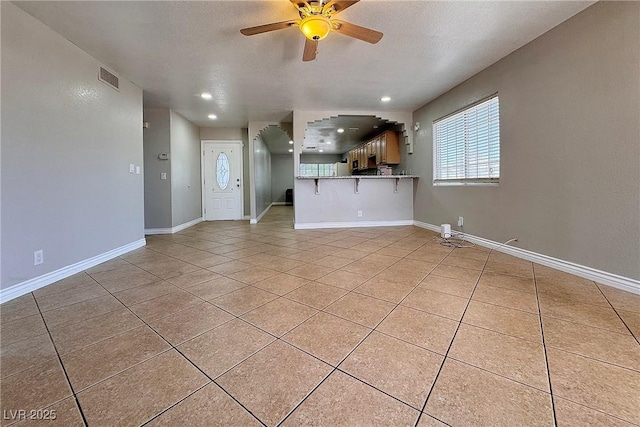 6929 Montcliff Ave, Las Vegas, NV 89147 - unfurnished living room with ceiling fan, light tile patterned floors, recessed lighting, baseboards, and a textured ceiling