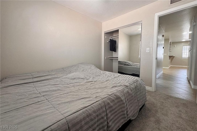 6929 Montcliff Ave, Las Vegas, NV 89147 - carpeted bedroom featuring baseboards, a closet, and tile patterned floors