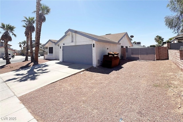 6929 Montcliff Ave, Las Vegas, NV 89147 - view of front of property with an attached garage, concrete driveway, stucco siding, and a gate