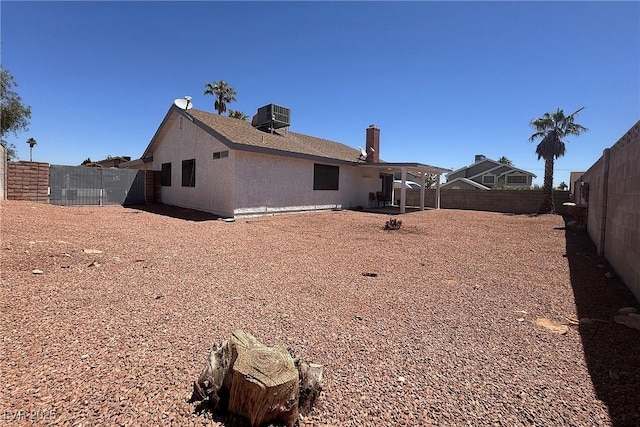 6929 Montcliff Ave, Las Vegas, NV 89147 - back of property featuring central AC, a fenced backyard, and a patio