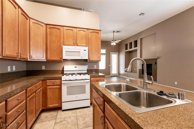 9025 Rusty Rifle Ave, Las Vegas, NV 89143 - kitchen featuring white appliances, a sink, ceiling fan, brown cabinetry, and tile countertops