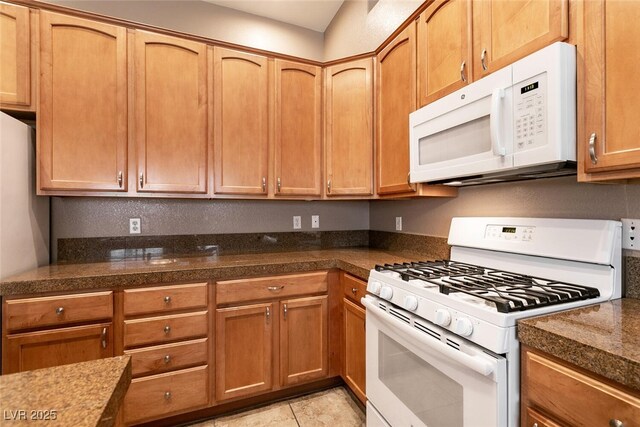 9025 Rusty Rifle Ave, Las Vegas, NV 89143 - kitchen featuring white appliances and brown cabinetry