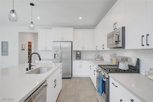 1321 Hudson Creek Pl, North Las Vegas, NV 89084 - kitchen featuring stainless steel appliances, a sink, light countertops, hanging light fixtures, and decorative backsplash