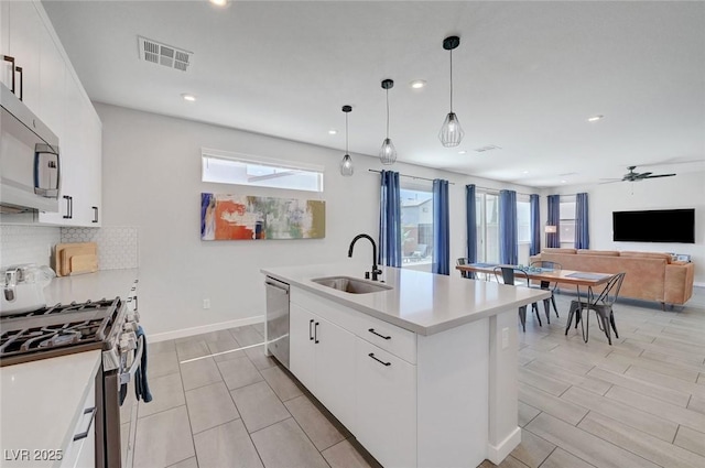 1321 Hudson Creek Pl, North Las Vegas, NV 89084 - kitchen featuring a sink, stainless steel appliances, recessed lighting, backsplash, and a ceiling fan