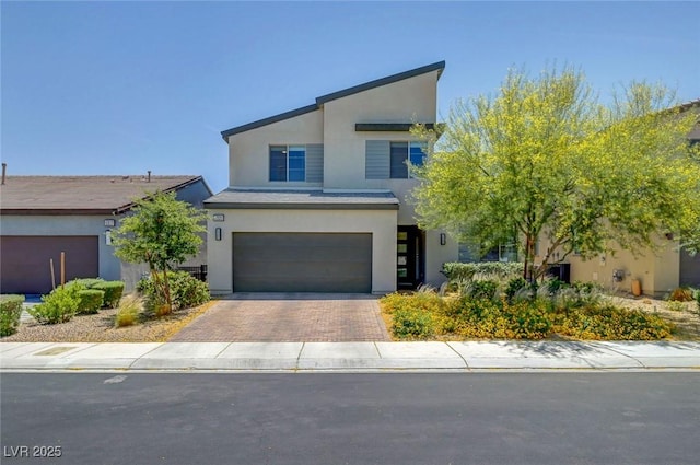 1321 Hudson Creek Pl, North Las Vegas, NV 89084 - view of front of house with stucco siding, an attached garage, and decorative driveway
