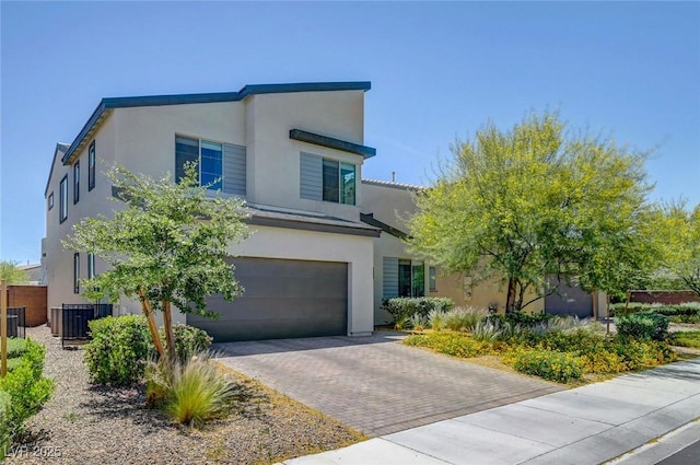 1321 Hudson Creek Pl, North Las Vegas, NV 89084 - view of front of house featuring stucco siding, a garage, decorative driveway, and central air condition unit