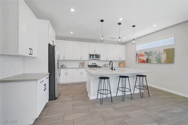 1321 Hudson Creek Pl, North Las Vegas, NV 89084 - kitchen featuring stainless steel appliances, tasteful backsplash, a kitchen bar, white cabinets, and recessed lighting