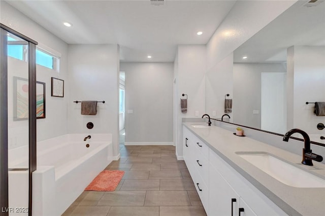 1321 Hudson Creek Pl, North Las Vegas, NV 89084 - full bath featuring a garden tub, double vanity, baseboards, recessed lighting, and tile patterned floors