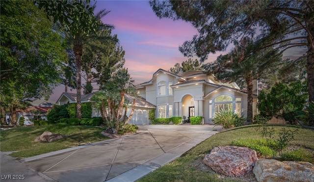 2346 Villandry Ct, Henderson, NV 89074 - mediterranean / spanish-style home featuring driveway, stucco siding, an attached garage, and a lawn