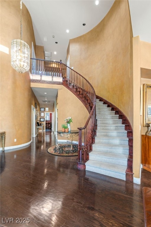 2346 Villandry Ct, Henderson, NV 89074 - entryway featuring stairs, a towering ceiling, a chandelier, wood finished floors, and baseboards