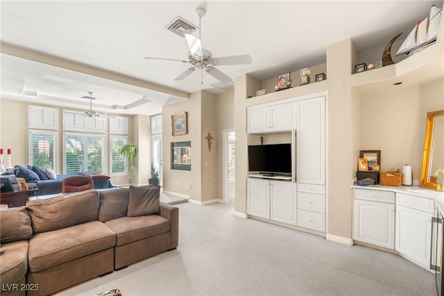 2346 Villandry Ct, Henderson, NV 89074 - living area with light carpet, a ceiling fan, baseboards, and a tray ceiling
