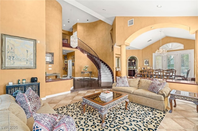 2346 Villandry Ct, Henderson, NV 89074 - living room with decorative columns, arched walkways, a chandelier, stairs, and high vaulted ceiling