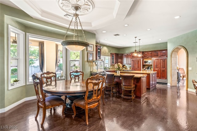 2346 Villandry Ct, Henderson, NV 89074 - dining space featuring baseboards, arched walkways, dark wood finished floors, recessed lighting, and crown molding