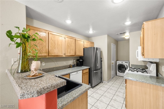 3464 Twilight Star Dr, Las Vegas, NV 89117 - kitchen with washer / dryer, white appliances, light countertops, light tile patterned floors, and light brown cabinets
