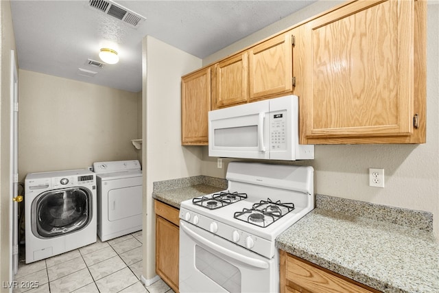 3464 Twilight Star Dr, Las Vegas, NV 89117 - kitchen featuring white appliances, washing machine and dryer, light tile patterned floors, and light brown cabinetry