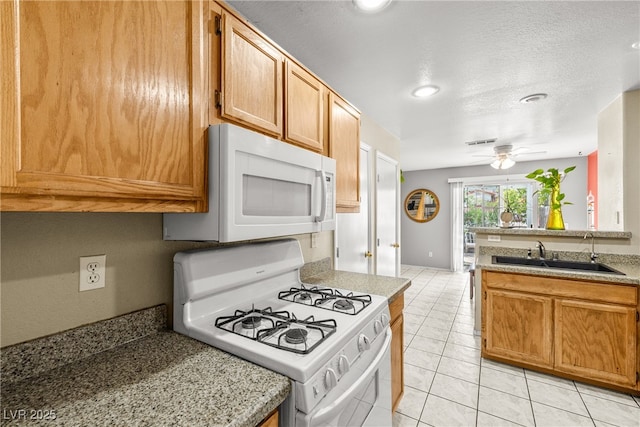 3464 Twilight Star Dr, Las Vegas, NV 89117 - kitchen with white appliances, light tile patterned flooring, ceiling fan, light countertops, and recessed lighting