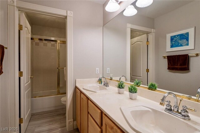 464 Beardsley Cir, Henderson, NV 89052 - full bathroom featuring double vanity, toilet, shower / bath combination with glass door, and wood finished floors