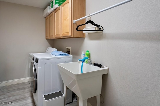 464 Beardsley Cir, Henderson, NV 89052 - laundry room with washing machine and dryer, cabinet space, baseboards, and light wood-style flooring