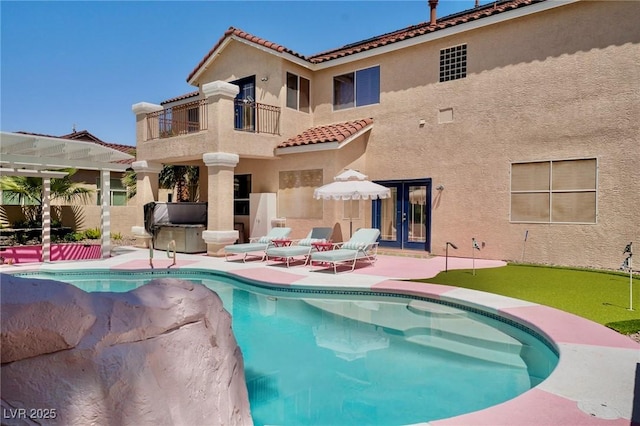 464 Beardsley Cir, Henderson, NV 89052 - rear view of property featuring a balcony, a tile roof, french doors, a patio, and an area to practice putting