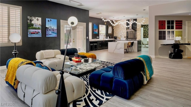 464 Beardsley Cir, Henderson, NV 89052 - living room with light wood-type flooring, plenty of natural light, and a chandelier