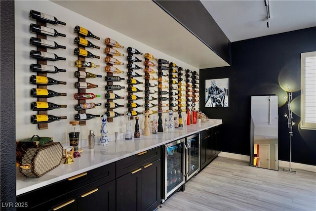 464 Beardsley Cir, Henderson, NV 89052 - wine area with wine cooler, light wood-style flooring, track lighting, and baseboards