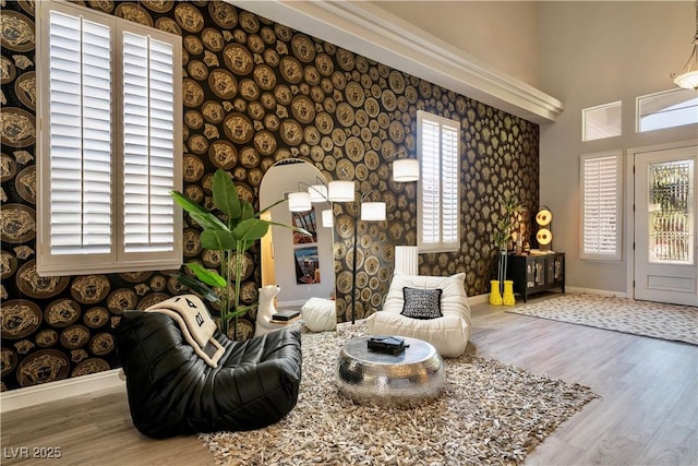 464 Beardsley Cir, Henderson, NV 89052 - living area featuring baseboards, wallpapered walls, wood finished floors, and a towering ceiling