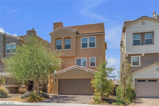 156 Campbelltown Ave, Henderson, NV 89015 - view of front of home featuring an attached garage, stucco siding, decorative driveway, and a chimney