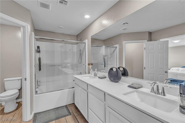 156 Campbelltown Ave, Henderson, NV 89015 - full bathroom with double vanity, toilet, wood finished floors, and shower / bath combination with glass door