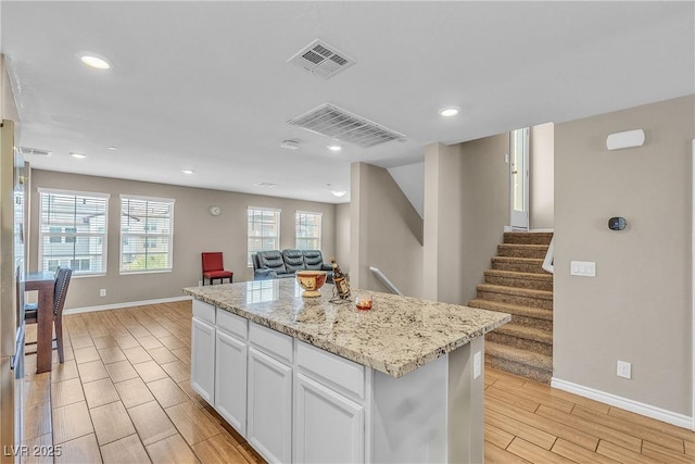 156 Campbelltown Ave, Henderson, NV 89015 - kitchen with wood finish floors, open floor plan, baseboards, recessed lighting, and white cabinets