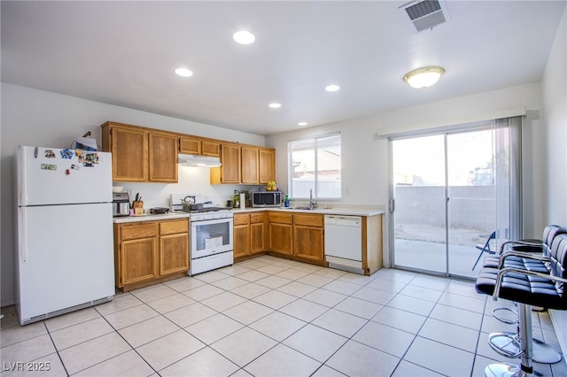 320 Ellen Marie Dr, Las Vegas, NV 89110 - kitchen featuring white appliances, under cabinet range hood, light countertops, a sink, and recessed lighting