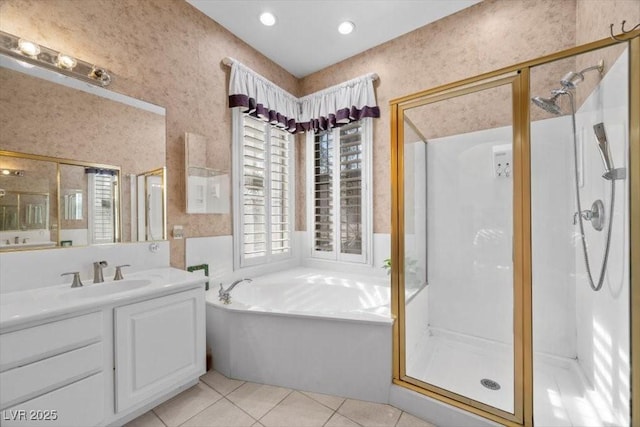 835 Market Crest Dr, Las Vegas, NV 89110 - bathroom featuring healthy amount of natural light, a shower stall, a garden tub, vanity, and wallpapered walls
