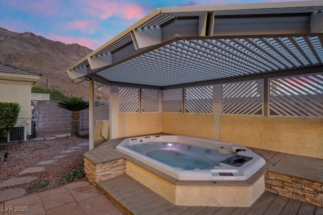 835 Market Crest Dr, Las Vegas, NV 89110 - view of patio featuring an outdoor hot tub, a mountain view, and central AC unit