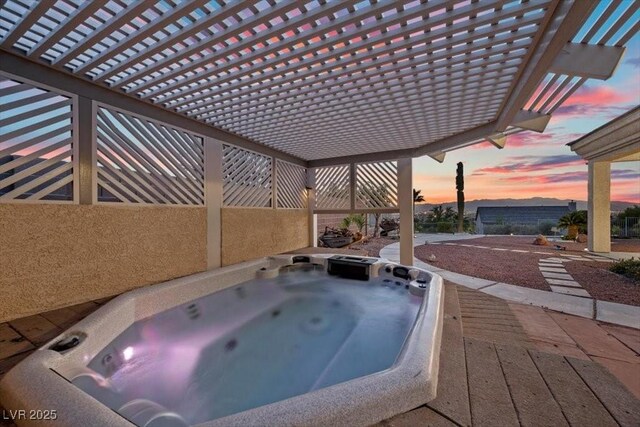 835 Market Crest Dr, Las Vegas, NV 89110 - pool at dusk with an outdoor hot tub and a pergola