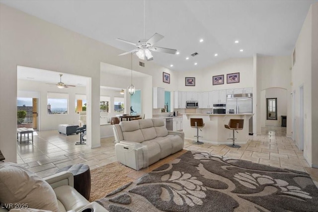 835 Market Crest Dr, Las Vegas, NV 89110 - living area with ceiling fan, high vaulted ceiling, recessed lighting, and stone tile flooring